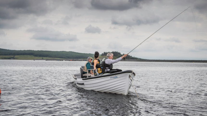 small fishing boat with angler casting a line